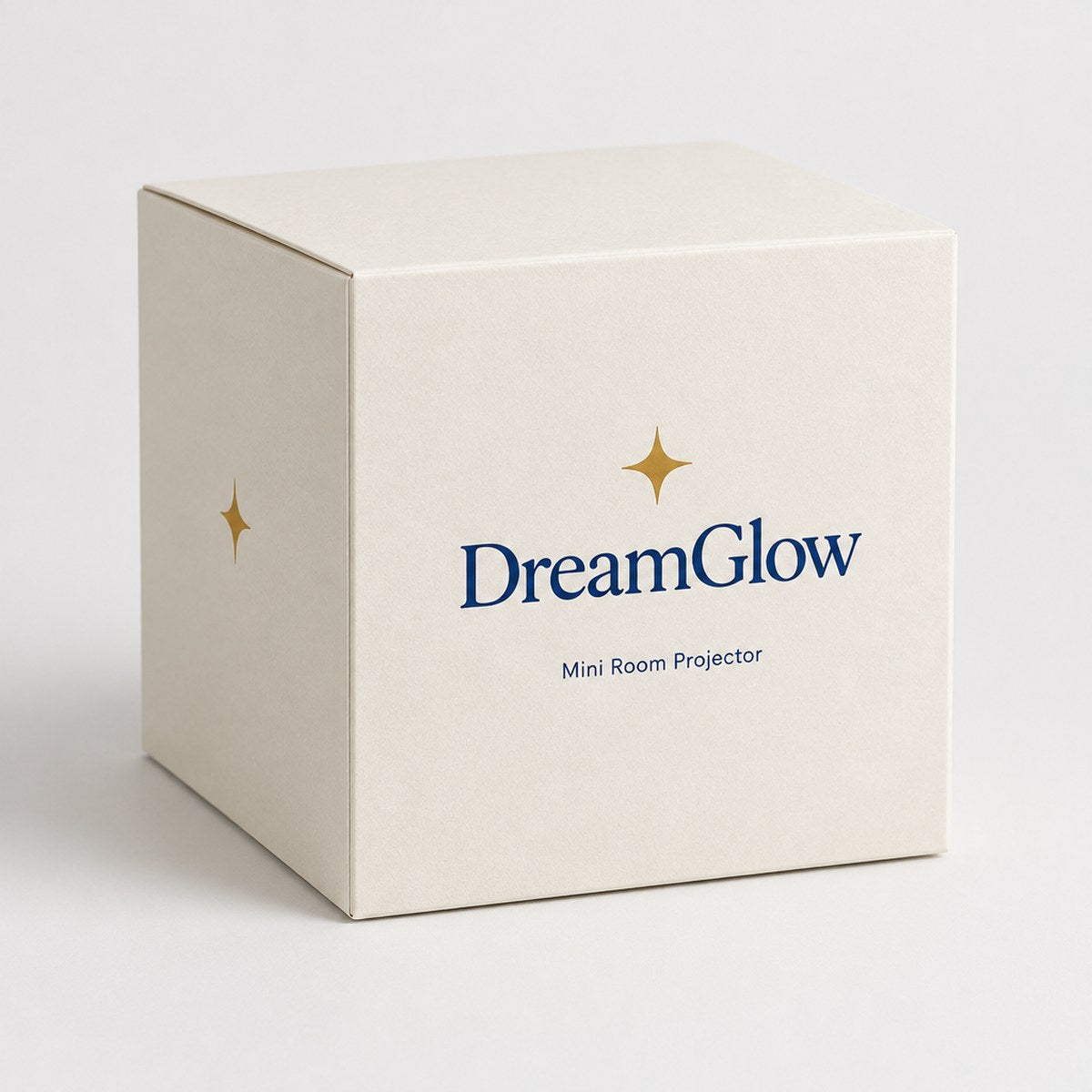 The DreamGlow box with the gold star logo and Mini Room Projector printed on it